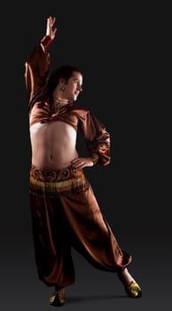 Man posing in brown oriental arabian costume