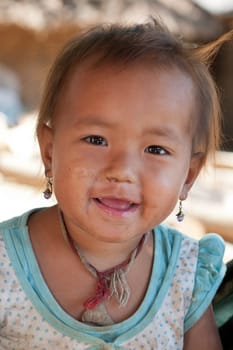 Portrait of asian child,with dirty face and poor clothes
