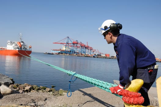 dock and port-worker, mooring ship outside busy commercial container-port