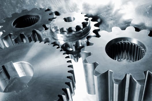 industrial titanium and steel gears mirrored in aluminum