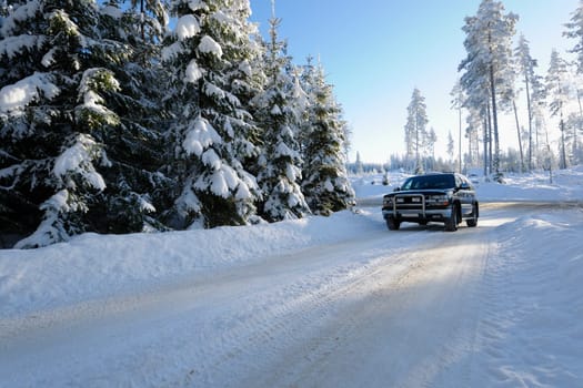 large suv, car, driving on snowy-road and a swedish winter landscape, ice and cold. own car, no trademarks