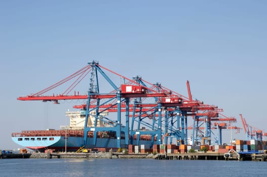 busy container-port and shipping, large ship waiting for cargo.