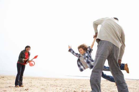 Young Family Relaxing On Beach Camping Holiday