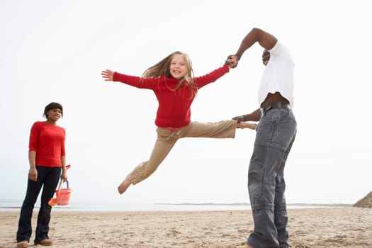 Young Family Relaxing On Beach Camping Holiday