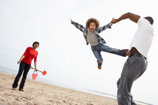 Young Family Relaxing On Beach Camping Holiday