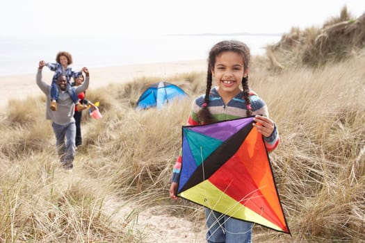 Family Having Fun With Kite In Sand Dunes