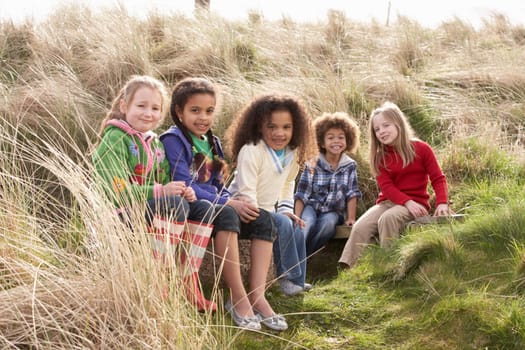 Group Of Children Playing In Field Together