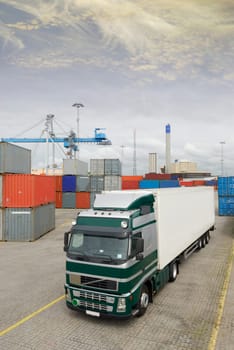 large truck with cargo standing inside busy commercial container-port