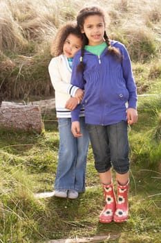 Young Girls Playing In Field Together