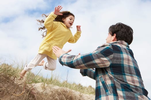 Father And Daughter Having Fun On Beach Together