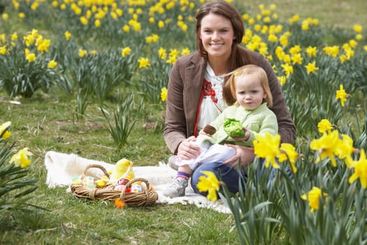Mother And Daughter In Daffodil Field With Decorated Easter Eggs