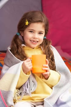 Young Girl Relaxing Inside Tent On Camping Holiday