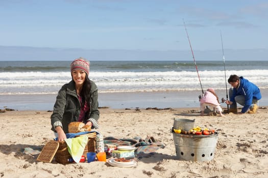 Family Having Picnic On Winter Beach