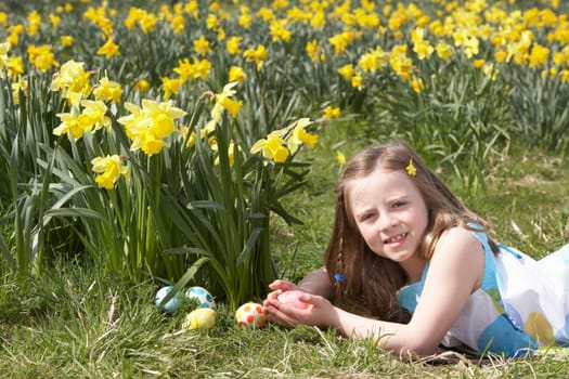 Girl On Easter Egg Hunt In Daffodil Field