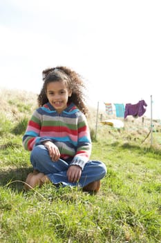 Young Girl Sitting Outside In Caravan Park