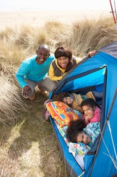 Young Family Relaxing Inside Tent On Camping Holiday