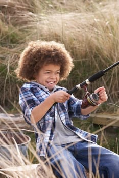 Young Boy Fishing At Seaside