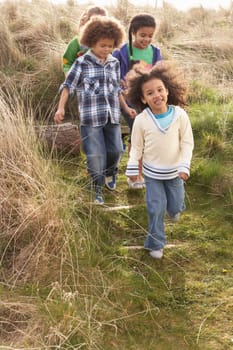 Group Of Children Playing In Field Together