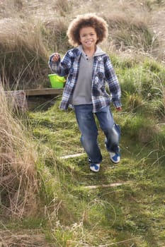 Young Boy Carrying Fishing Net At Seaside
