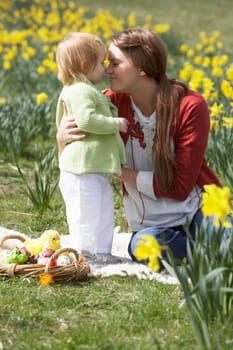 Mother And Daughter In Daffodil Field With Decorated Easter Eggs