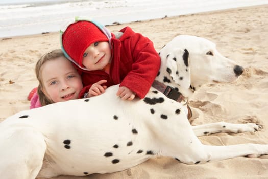 Two Girls On Beach With Pet Dog