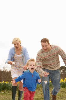 Family Having Egg And Spoon Race