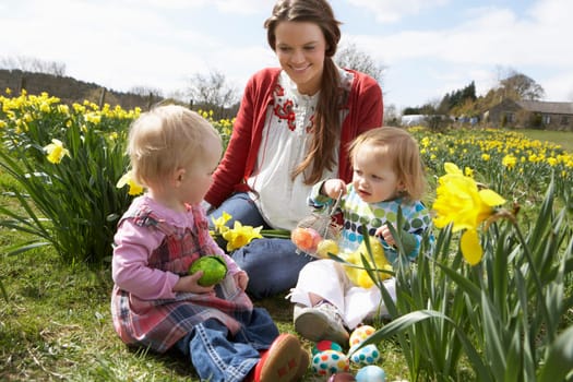 Mother And Daughter In Daffodil Field With Decorated Easter Eggs