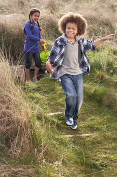 Young Children Carrying Fishing Net At Seaside