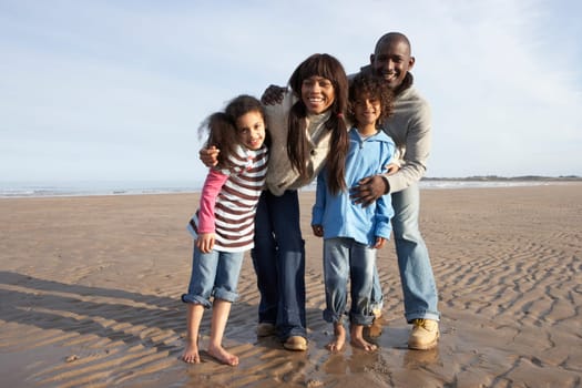 Family Walking On Winter Beach