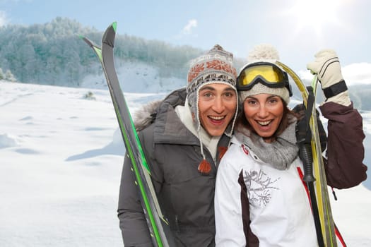 Happy couple in the mountains for ski vacation