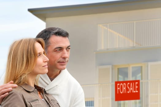 Couple in front of house for sale