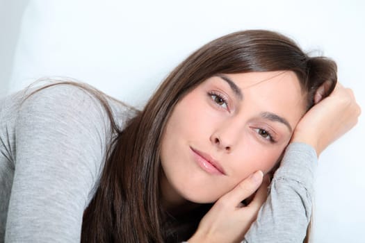 Closeup of young woman relaxing on sofa