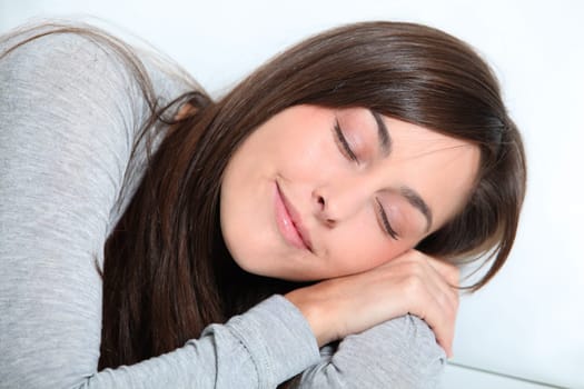Closeup of young woman relaxing on sofa