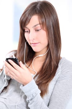 Closeup of young woman listening to music