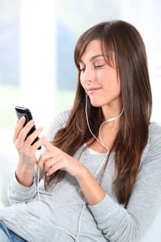 Closeup of young woman listening to music