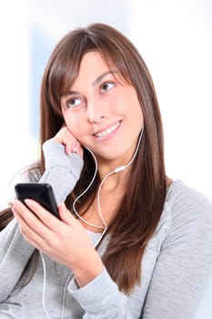 Closeup of young woman listening to music