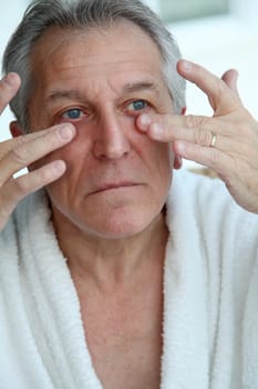 Senior man doing a face massage