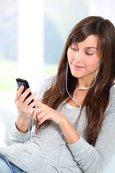Closeup of young woman listening to music