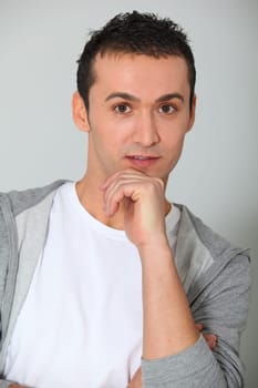 Closeup of young man with hand on chin