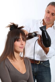 Hairdresser drying woman's hair