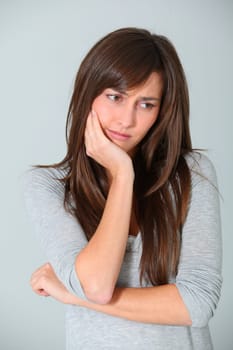 Closeup of young woman having a toothache