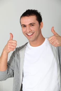Closeup of young man with thumbs up