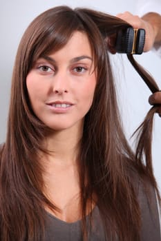 Beautiful woman having her hair dressed