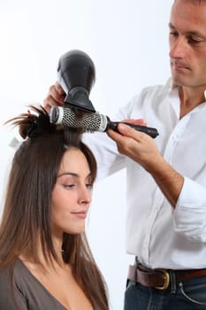 Hairdresser drying woman's hair