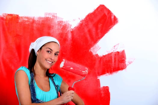 Young woman painting house wall in red