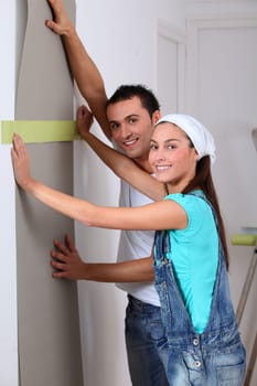 Young couple choosing color of wallpaper