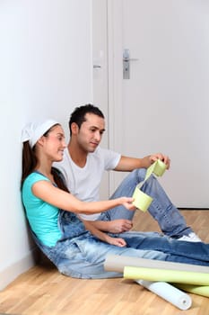 Young couple choosing color of wallpaper