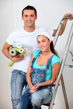 Young couple choosing color of wallpaper