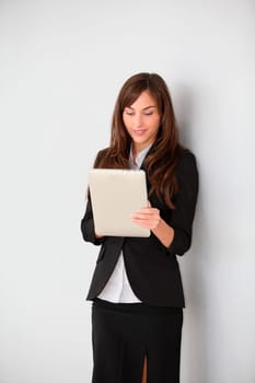 Businesswoman standing in hall with electronic pad