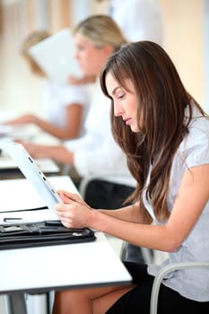 Businesswoman working in the office on electronic pad